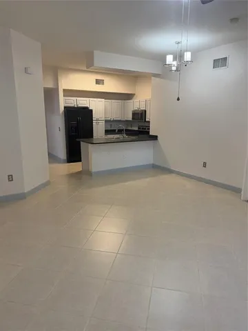 a kitchen with granite countertop a refrigerator and a stove