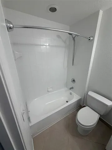 a front view of a house with cars parked