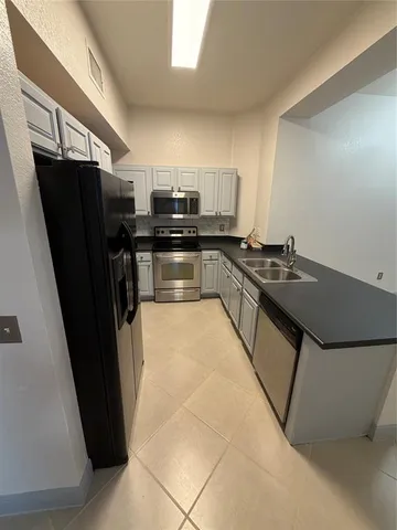 a kitchen with a sink and cabinets
