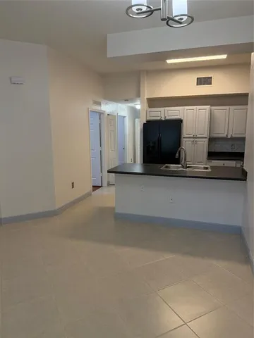 a kitchen with a sink and chandelier
