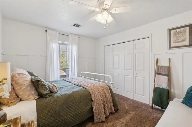 a bedroom with a bed and a mirror