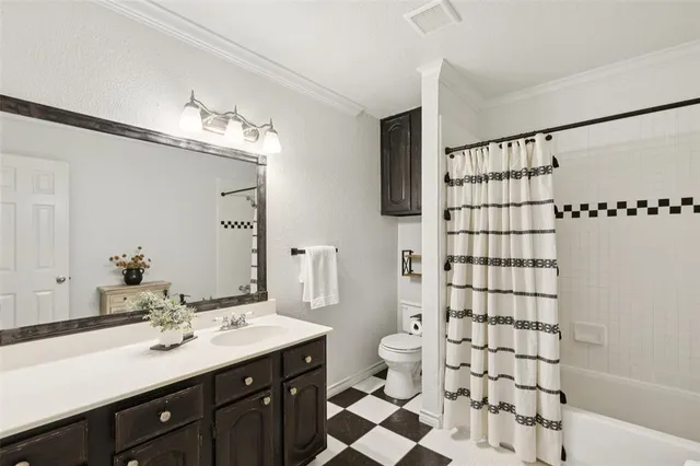 a bathroom with a double vanity sink toilet and shower