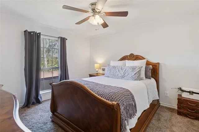 a bedroom with a bed chandelier and a window