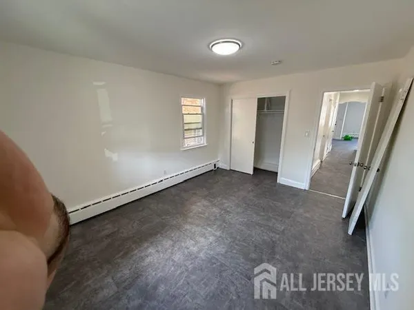 an empty room with windows and entrance