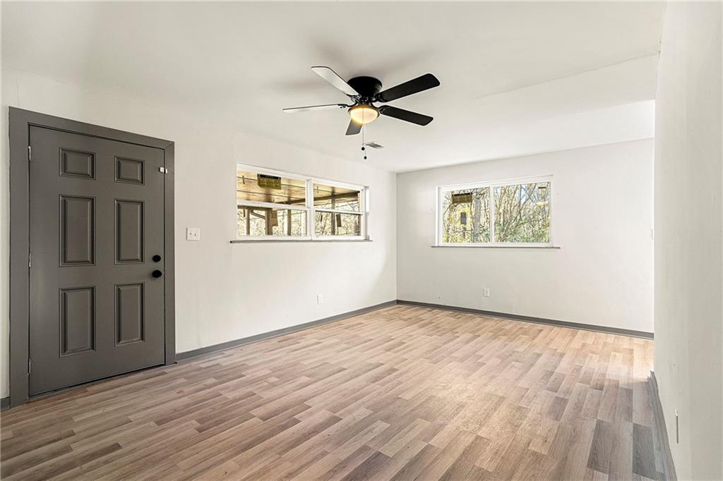4010 Boulder Park Drive Southwest Atlanta, GA 30331 - Photo 5 of 8 a view of empty room with wooden floor and fan