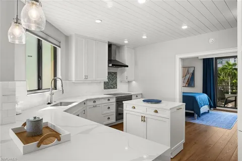 a kitchen that has a sink and a stove in it