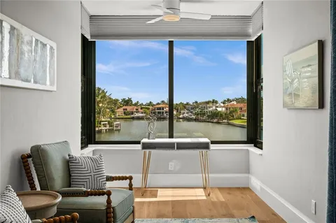 a living room with furniture and a floor to ceiling window