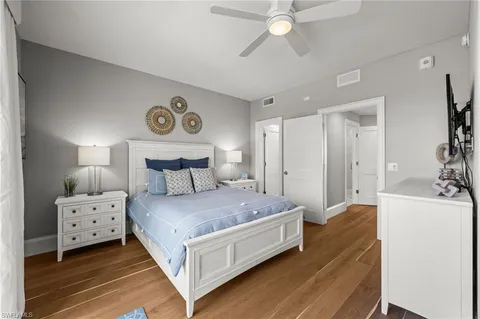 a spacious bedroom with a bed and a chandelier