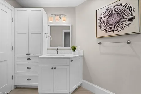 a bathroom with a sink a mirror and a vanity