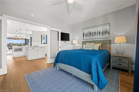 a bedroom with a bed and a view of kitchen
