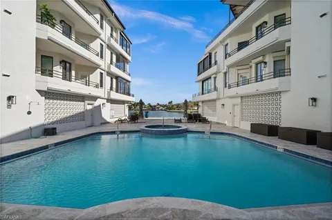 a view of pool with seating area