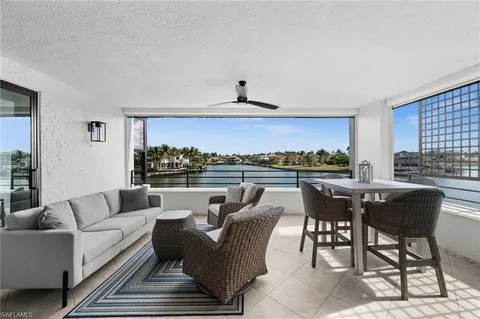 a living room with furniture and a kitchen