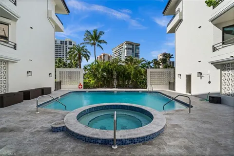 a view of a swimming pool with outdoor seating