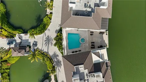 an aerial view of a house with a garden and trees