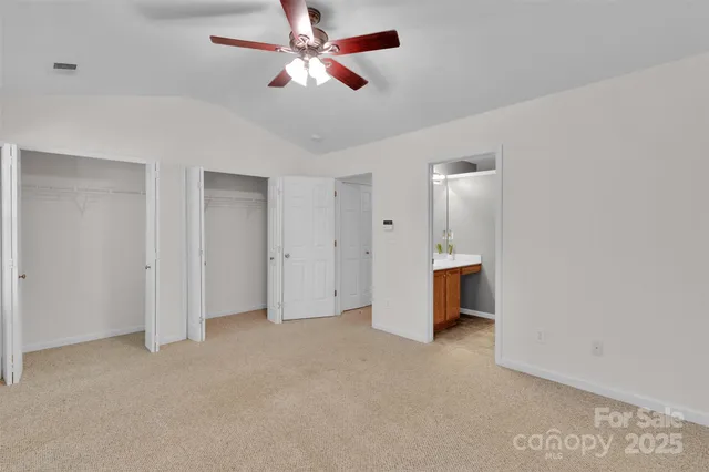 a view of an empty room with a ceiling fan