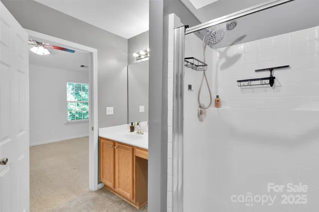 a bathroom with a shower sink and mirror