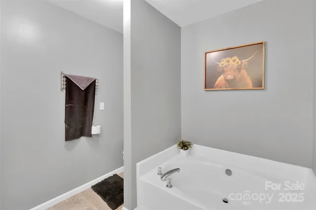 a bathroom with a bathtub and a window