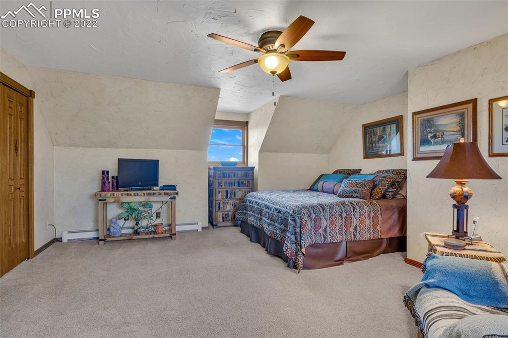 620 Crestview Drive Florence, CO 81226 - Photo 24 of 49 a bedroom with a bed and a chandelier