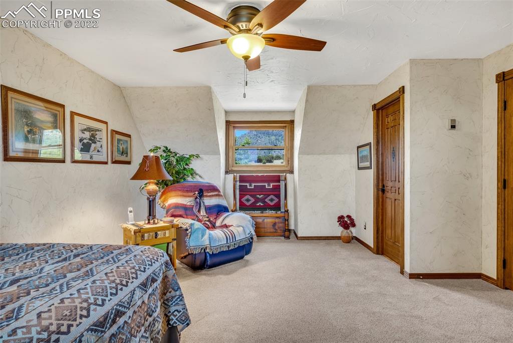 620 Crestview Drive Florence, CO 81226 - Photo 25 of 49 a bedroom with bed and a chandelier