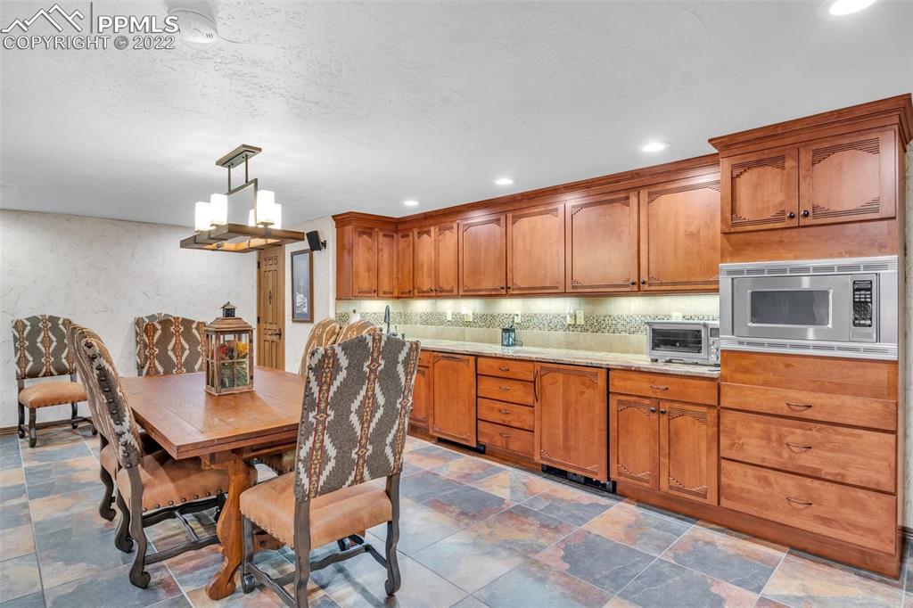620 Crestview Drive Florence, CO 81226 - Photo 29 of 49 a room with granite countertop furniture a fireplace and wooden floor
