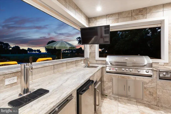 a view of a chair and table on the roof deck