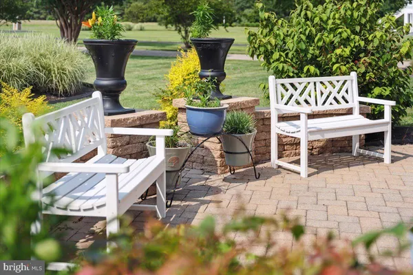 a view of a lake with a table and chairs