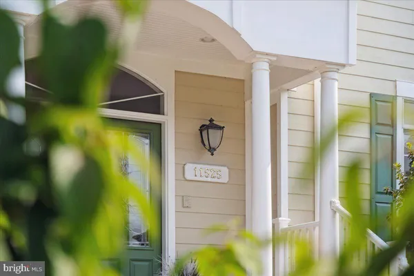 a living room with furniture a rug and a floor to ceiling window