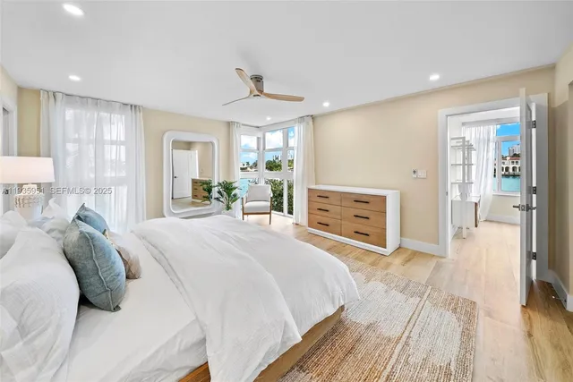 a spacious bedroom with a bed and a chandelier