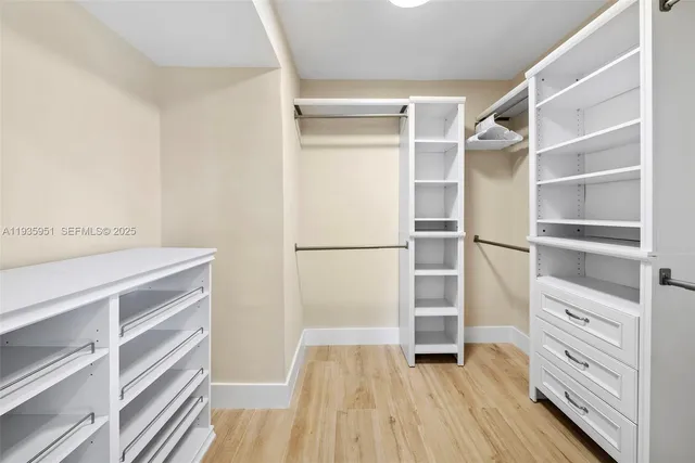 a view of walk in closet with empty racks