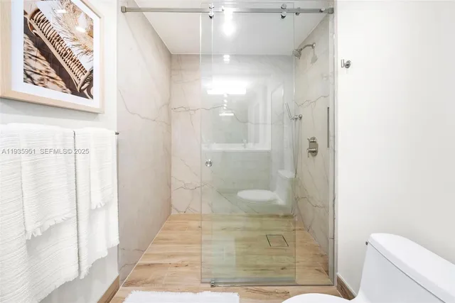 a bathroom with a shower and toilet