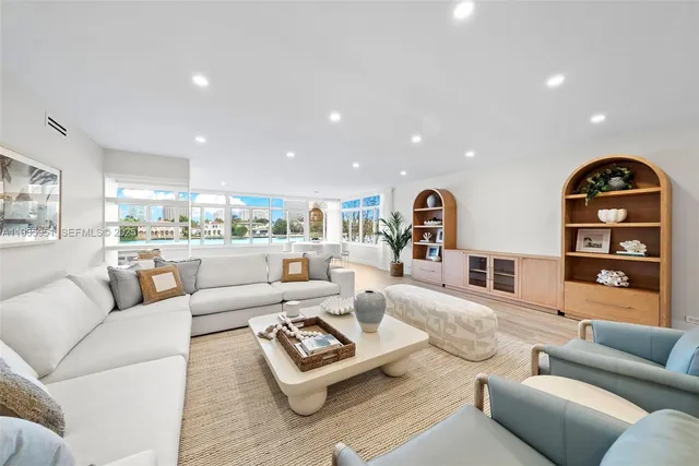 a living room with furniture kitchen view and a couch