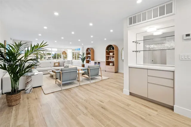 a living room with furniture and view of kitchen