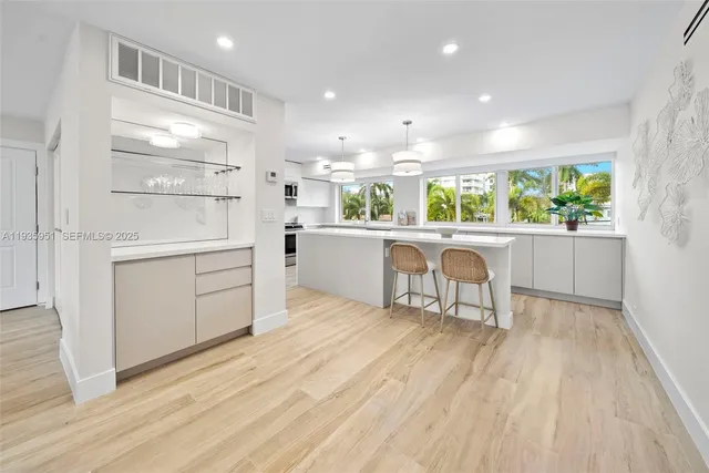a kitchen with a wooden floor and white cabinets