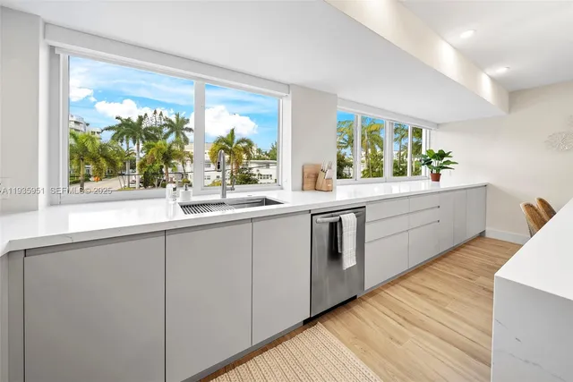 a kitchen with a sink and large window