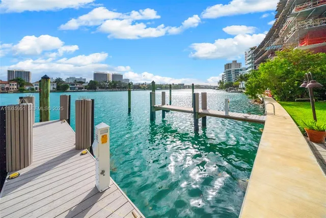 a view of a lake with couches and wooden floor