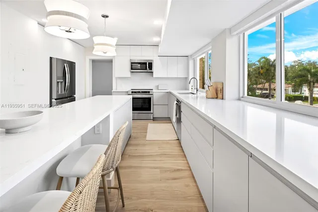 a large kitchen with a table and chairs in it