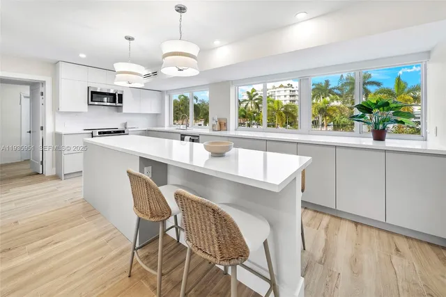 a large kitchen with a table and chairs
