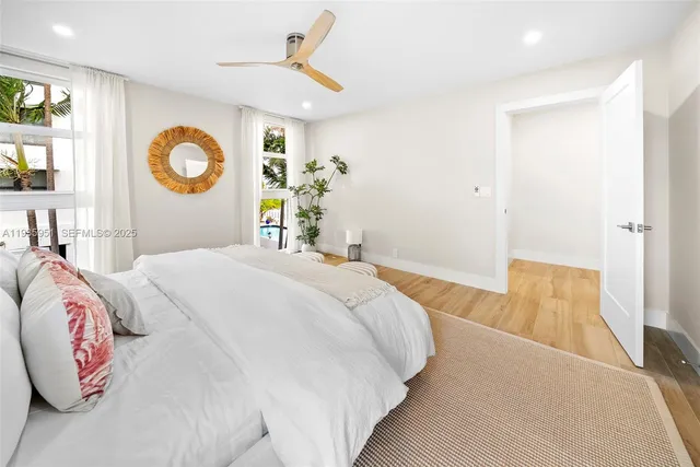 a bedroom with a large bed and a potted plant