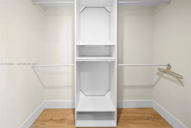 a bathroom with a granite countertop sink toilet mirror and bathtub