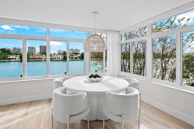 a dining room with furniture a chandelier and wooden floor