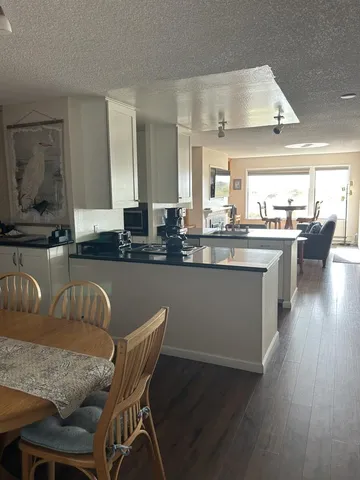 a dining table with chairs and wooden floor