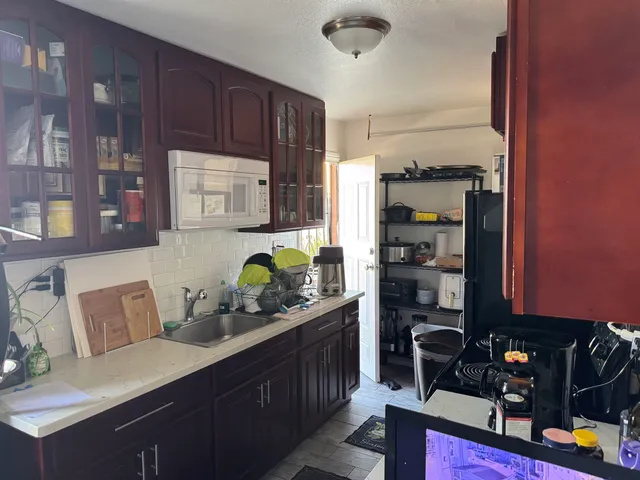 a kitchen with stainless steel appliances a sink a stove and refrigerator