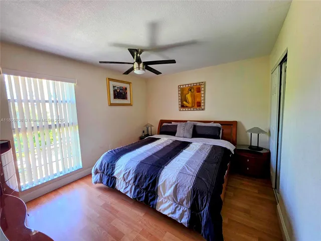 a bedroom with bed and window