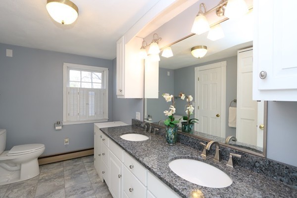 85 Schoolmasters Lane Dedham, MA 02026 - Photo 13 of 30 a bathroom with a granite countertop double vanity sink a mirror and a toilet