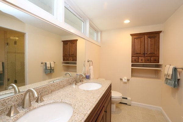 85 Schoolmasters Lane Dedham, MA 02026 - Photo 5 of 30 a bathroom with a granite countertop sink and a mirror