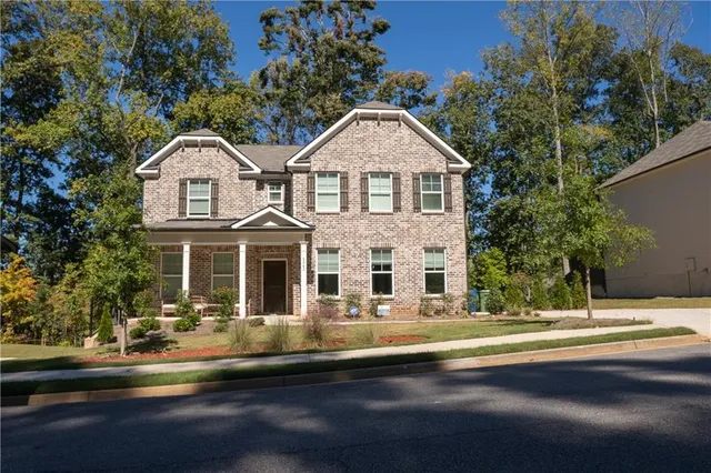 a front view of a house with a yard
