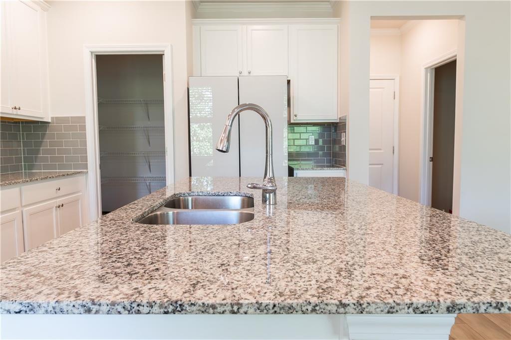 4545 Ajo Walk Atlanta, GA 30331 - Photo 12 of 28 a kitchen with sink a refrigerator and faucet