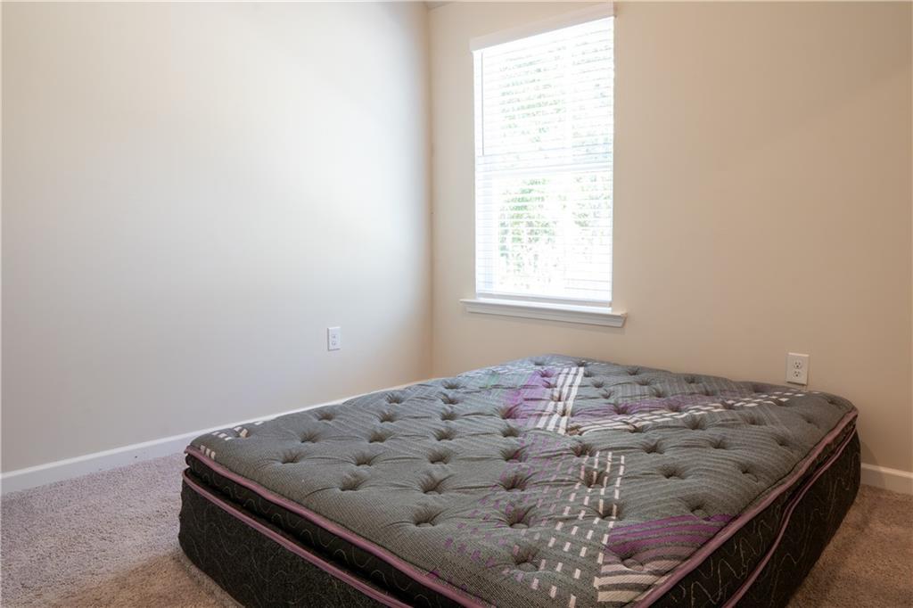 4545 Ajo Walk Atlanta, GA 30331 - Photo 19 of 28 a bed sitting in a bedroom next to a window