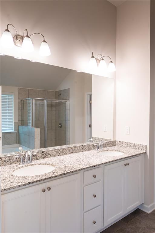 4545 Ajo Walk Atlanta, GA 30331 - Photo 23 of 28 a bathroom with a granite countertop sink and a mirror