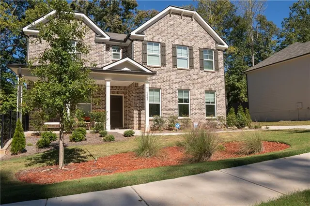 a front view of a house with garden